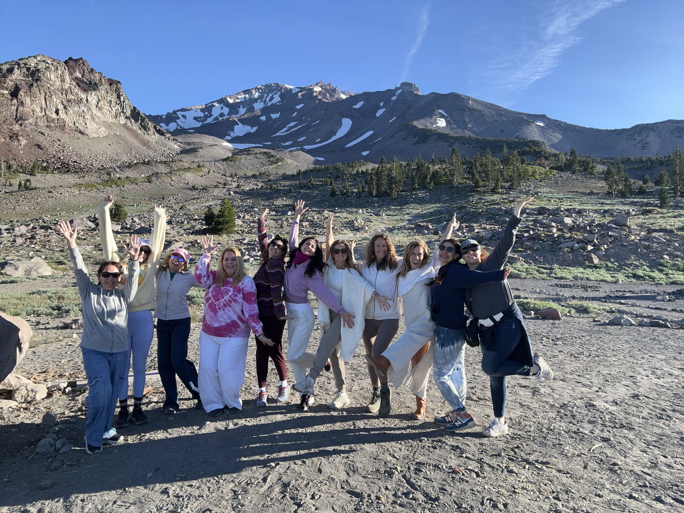 Retreat group with arms raised on Mount Shasta